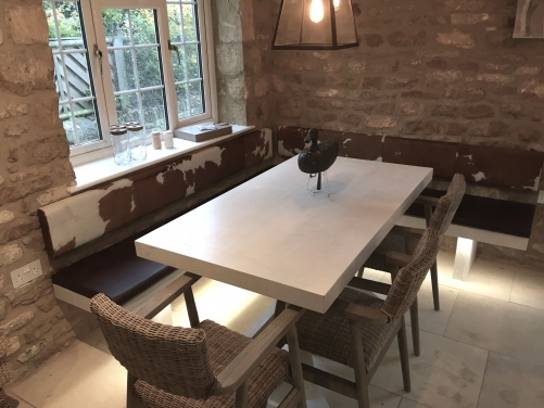 cowhide backrests and leather seating for dining area.