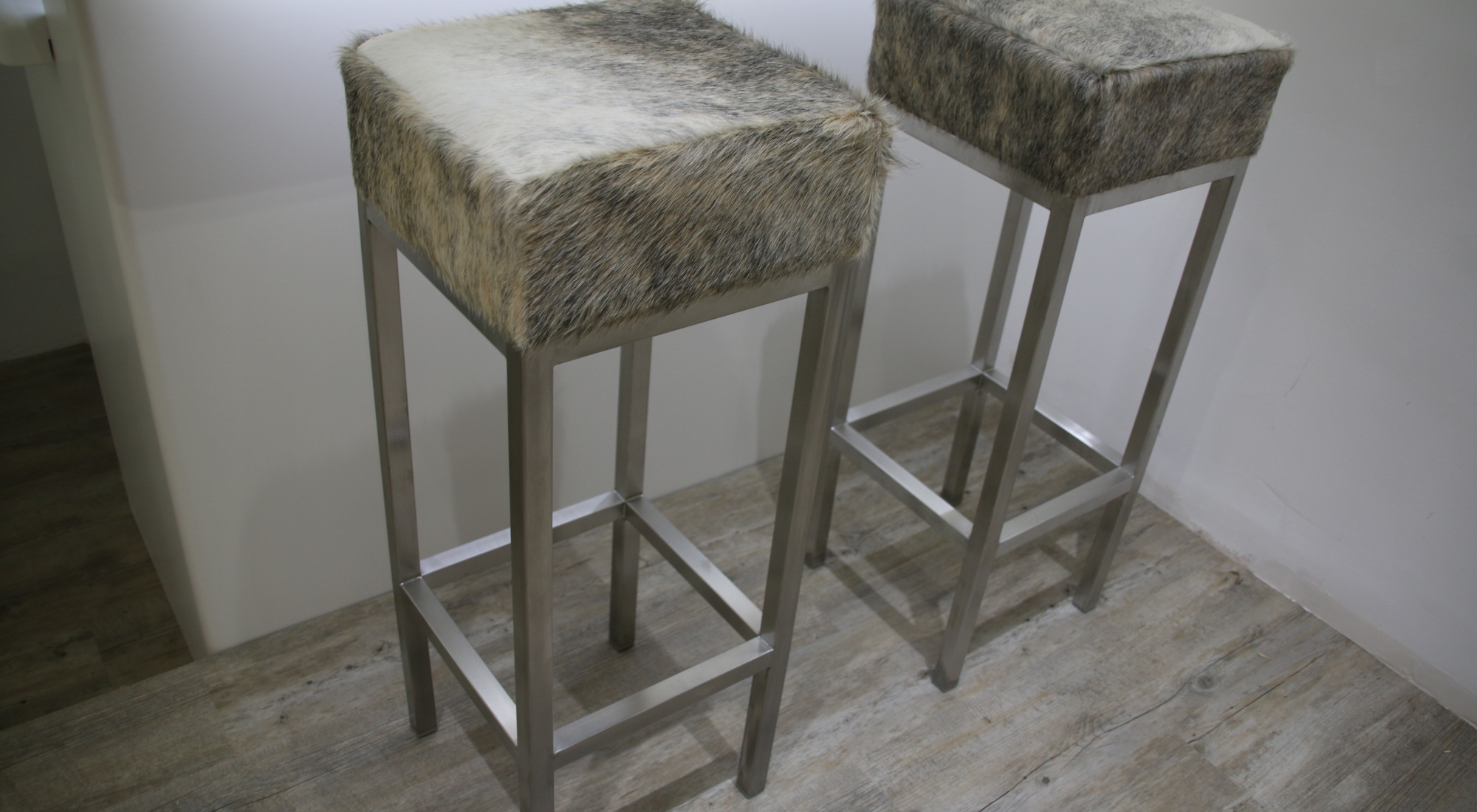grey and white cowhide stools