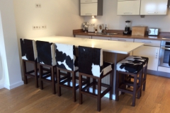 Cowhide bar stools in French chalet.
