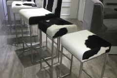 black and white cowhide bar stools with steel frames