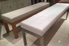 Deep button leather benches with oak and stainless steel frames.