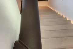 Stitching on ends and seam lines of oval leather handrail. Chelsea Creek project.