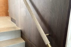 Solid brass finials on velour covered handrail.