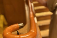 Tan leather applied to curving timber handrail.