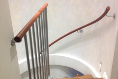 curving wall mounted leather handrail.