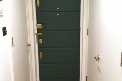 Leather panels applied to interior front door of London apartment.