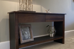 zebrano wood and leather console unit stained dark to co-ordinate with interior.