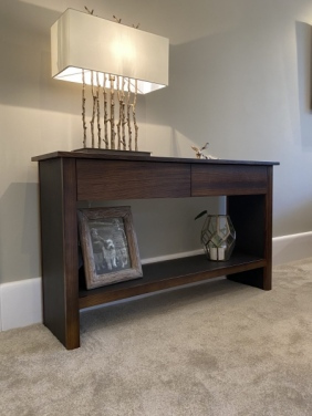 zebrano wood and leather console unit stained dark to co-ordinate with interior.