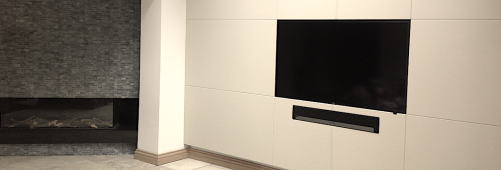 Leather wall panels surrounding TV and audio equipment.