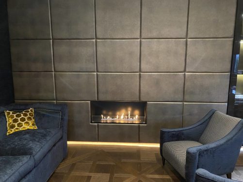 shagreen embossed leather wall panels around fireplace.