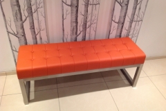Statement 'orange' leather bench with padded 'deep button' effect seat and brushed stainless steel frame.