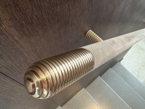 Cone shaped brass finials with suede handrails.