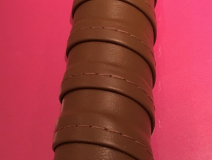 Tennis racket wrap style leather handrail with stitch detail.