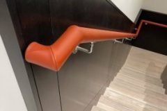 A continuous length of handrail covered in leather on-site by our skilled team.