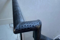 Croc print leather handrail on glass balustrade.