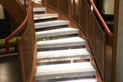 Tan leather handrail in London Hotel.