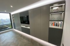 Wall to wall units with TV and lighting.