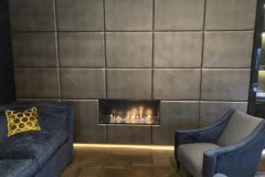 shagreen embossed leather wall panels around fireplace.