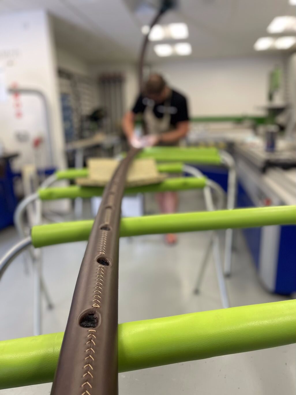 leatherwork on handrail Working on leather handrail in workshop